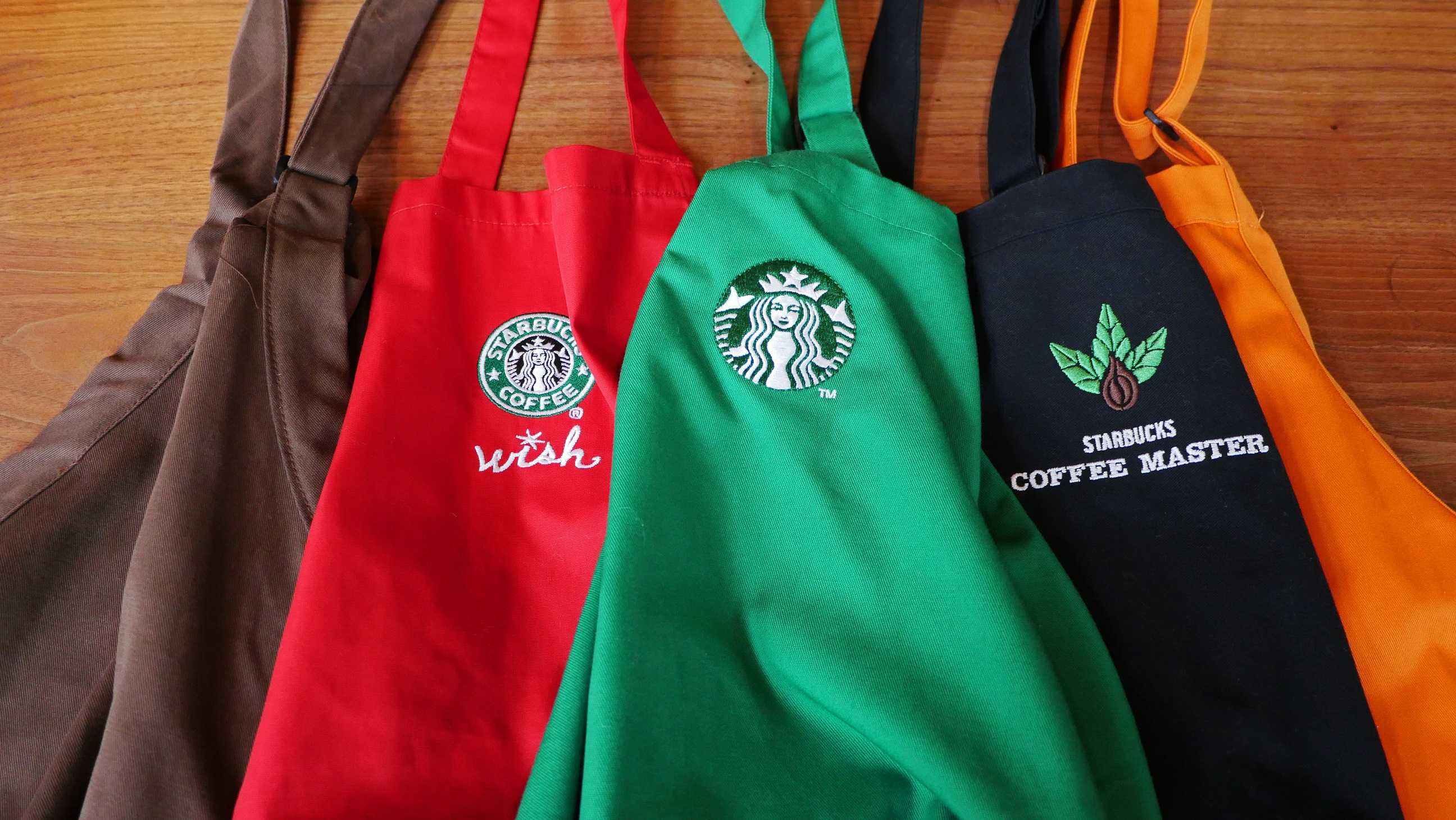 The Real Reason Starbucks Baristas Wear The Iconic Green Aprons 